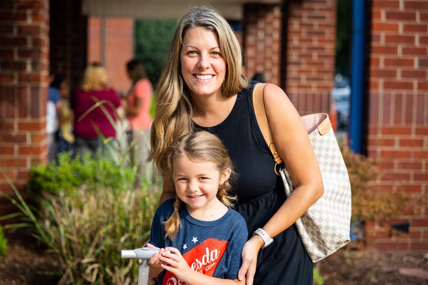 A family smiles on the first full day of kindergarten at Bethesda Elementary
